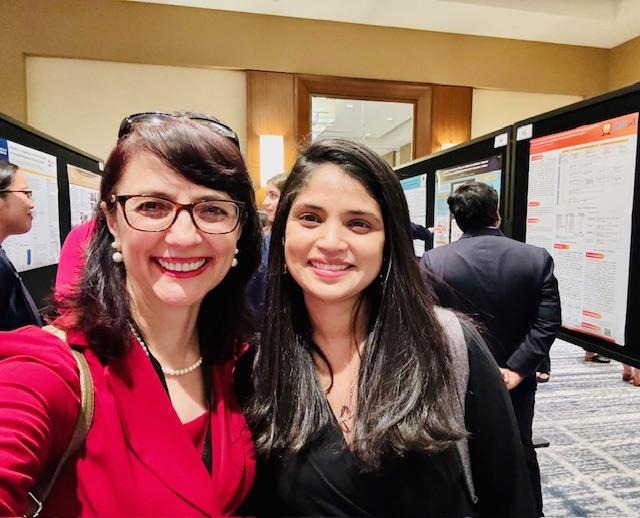 image - Indelible Learning Dr Criley and Dr Rohini (President of AMSA – American Medical Student Association) at the conference poster sessions, giving feedback to presenters and continuing to mentor with insights and advice.